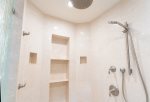 The beautiful walk-in shower features custom etched glass